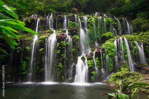 Fototapeta Naklejka Na Ścianę i Meble -  Waterfall landscape. Beautiful hidden waterfall in tropical rainforest. Nature background. Slow shutter speed, motion photography. Banyu Wana Amertha waterfall, Bali, Indonesia