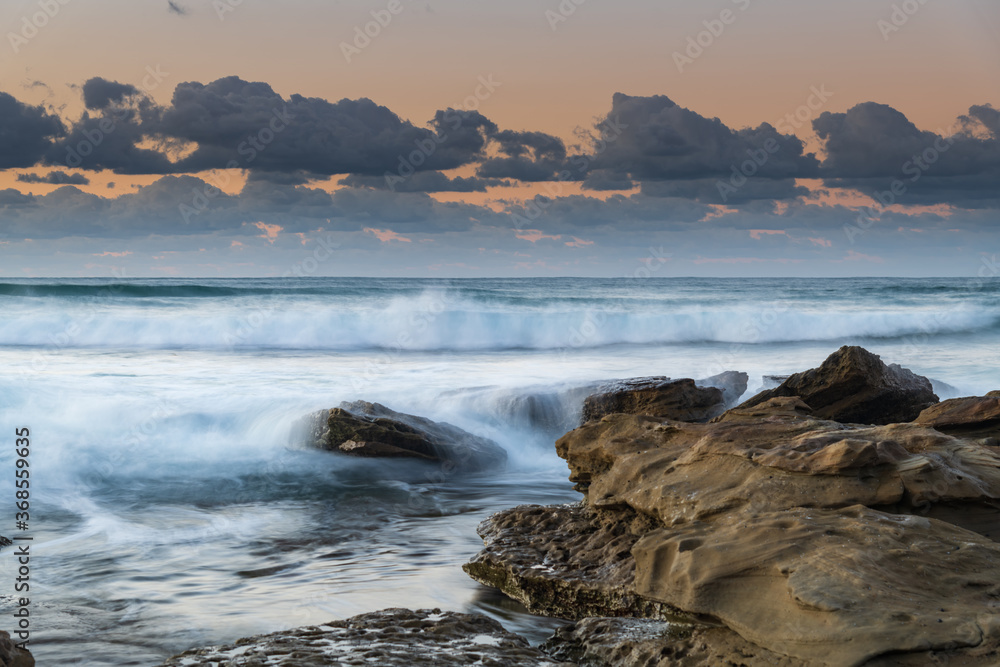 Fototapeta premium Sunrise Seascape with a low cloud bank and waves