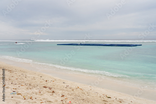 people in floating platform playing in the water in front of the Hulumale beach with white water and white sand photo