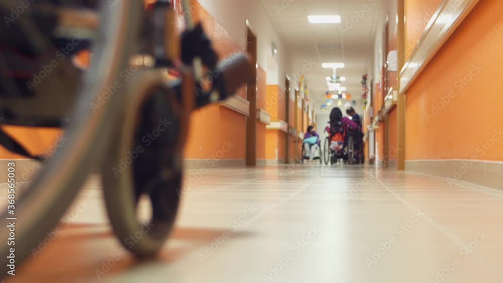 disabled man safely drives wheelchair in corridor institution slow motion disabled man safely drives wheelchair in corridor institution slow motion