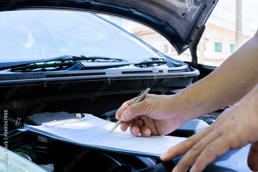 Professional auto mechanic working in repairing service, close-up. Car diagnostics concept Professional auto mechanic working in repairing service, close-up. Car diagnostics concept