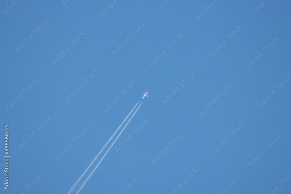 passenger plane flies high in the sky and forms a contrail passenger plane flies high in the sky and forms a contrail