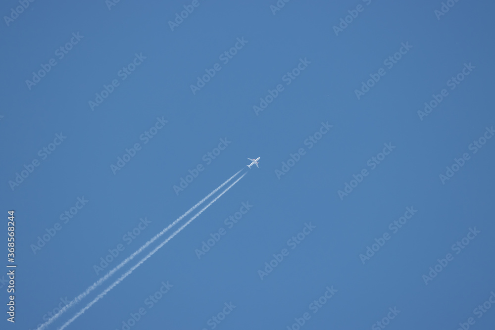 passenger plane flies high in the sky and forms a contrail passenger plane flies high in the sky and forms a contrail