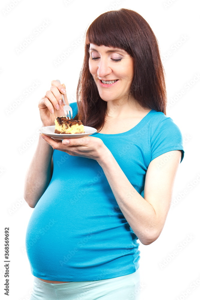 Pregnant woman eating fresh cheesecake, concept of nutrition during pregnancy Pregnant woman eating fresh cheesecake, concept of nutrition during pregnancy