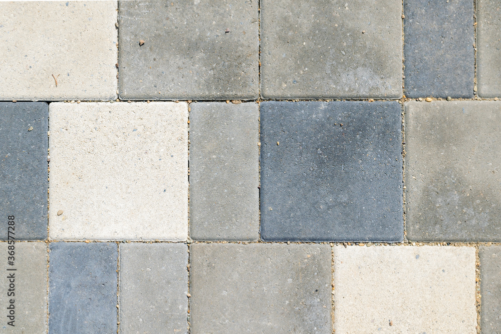 Naklejka premium Paving slabs, top view. Texture of paved tiles. Stone floor.