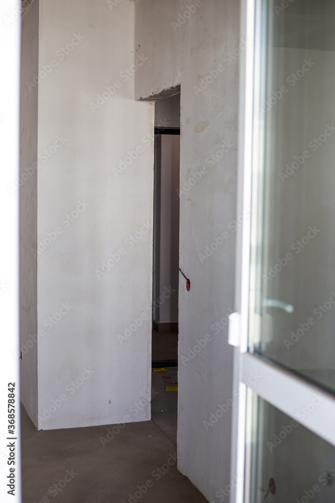 Prefinishing finishing of the premises. The walls in the room are ready for renovation. Construction and real estate. Prefinishing finishing of the premises. The walls in the room are ready for renovation. Construction and real estate.