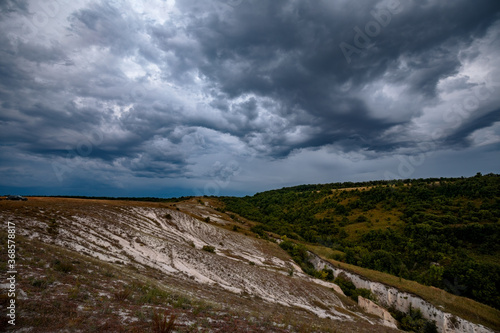 Embossed thunderclouds in the limestone hills of the Voronezh region photo