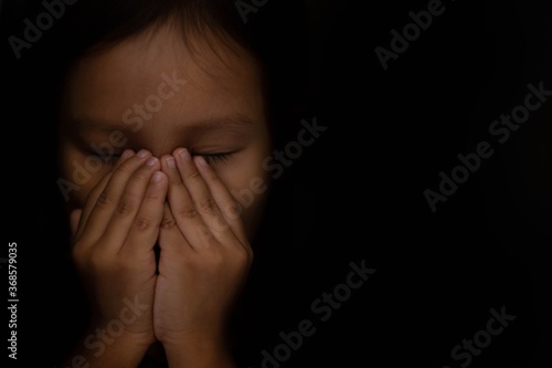 Wallpaper Mural Distressed little girl hiding in the dark shadows covering her face. Torontodigital.ca