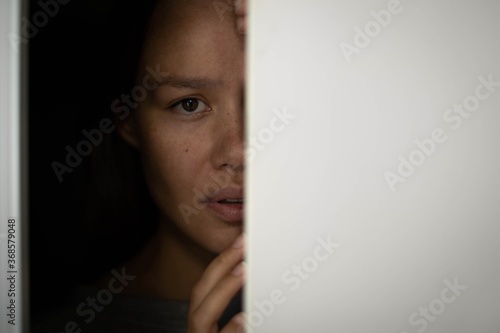 Εκτύπωση καμβά Woman hiding in the closet afraid with worry in her eyes.
