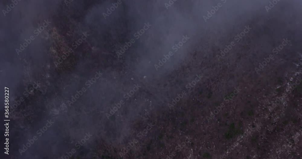 Fog and clouds cover a mountain terrain. Shot from above in 4k ariel by drone. Great for scary events, holloween, or anythng related to the mountains or mother nature Fog and clouds cover a mountain terrain. Shot from above in 4k ariel by drone. Great for scary events, holloween, or anythng related to the mountains or mother nature