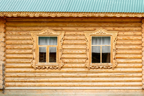 window in the old house. wooden house. Russian hut. Wooden decorative window in a log house. Russian traditional architecture.