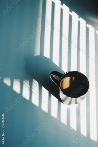 Morning coffee mug with office window shade