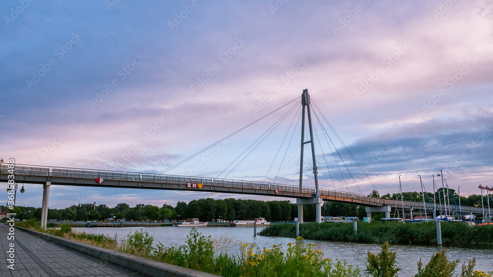 Modern pedestrian bridge In Gizycko Port during sunrise, Poland.