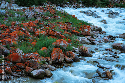 A creek with red rocks in Conch Gully of Sichuan, China, on a cloudy day. photo