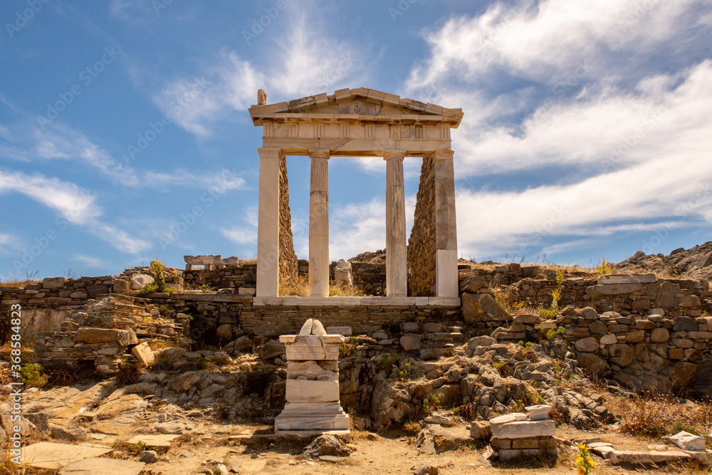 Well preserved Temple of Isis on Delos Island located on the hill above the ancient city with blue sky in the background, Greece. 