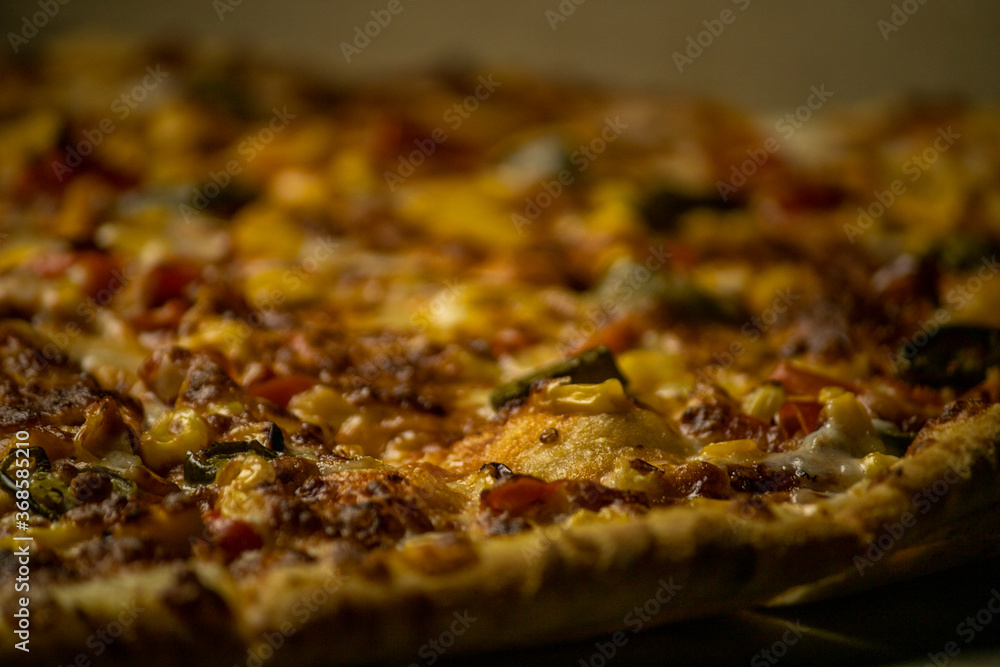 Pizza with dark background selective focus on middle Pizza with dark background selective focus on middle