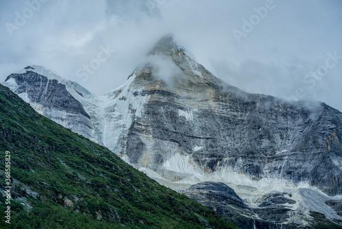 The snow mountains in Yading, Sichuan, China, summer time, on a cloudy day.