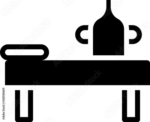 Black Massage table with oil icon isolated on white background. Vector.