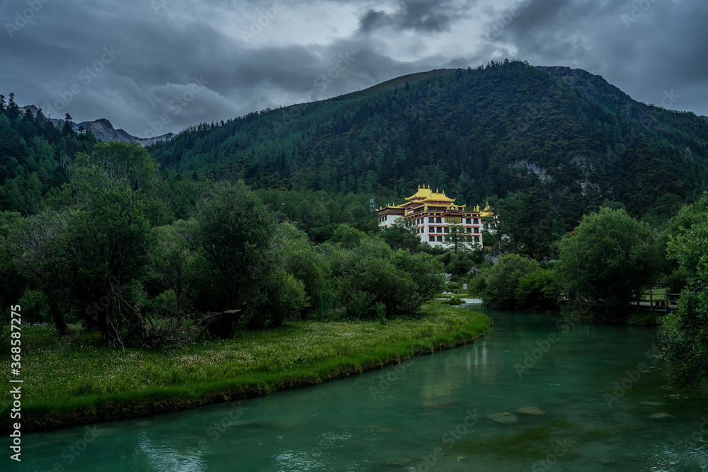 Chonggu Temple, a traditional Tibetan Temple in Yading, Sichuan, on a cloudy day, summer time.