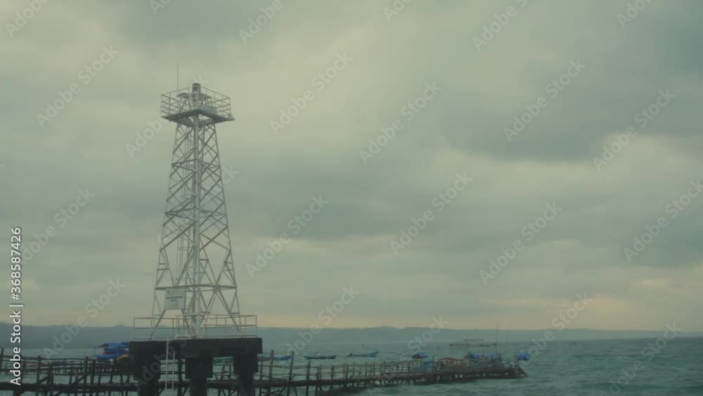 Time-lapse, sunrise with beacon tower in Pangandaran beach, West Java. Time-lapse, sunrise with beacon tower in Pangandaran beach, West Java.