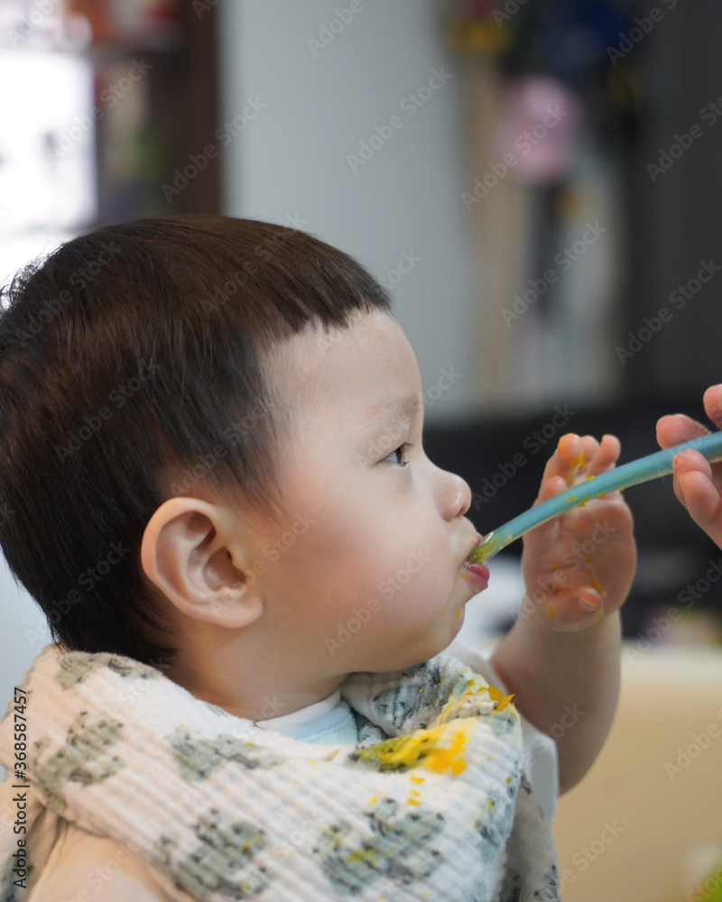 Little boy eating his food with spoon. Portrait little kid eating. Little boy eating his food with spoon. Portrait little kid eating.