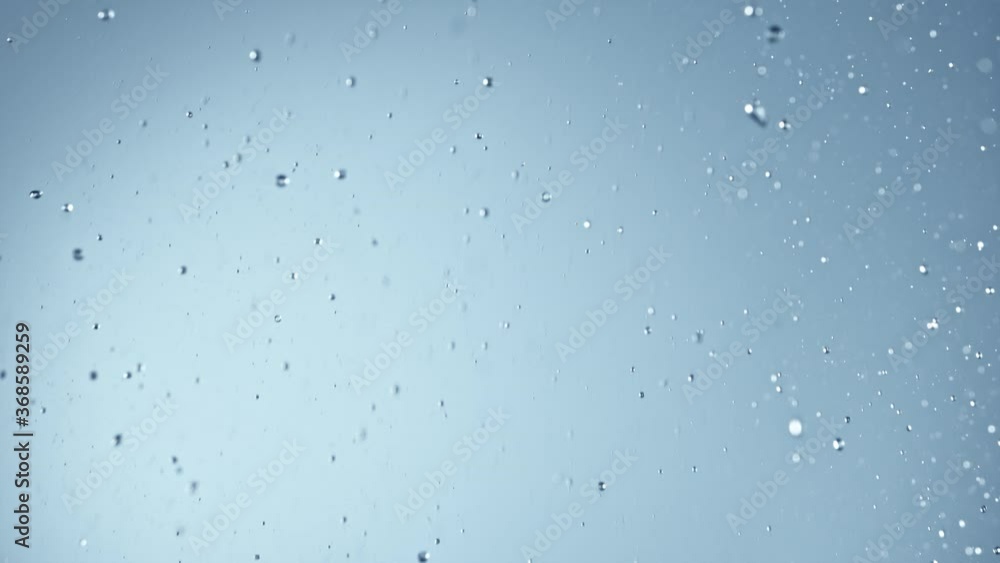 Super Slow Motion Shot of Falling Rain Drops at 1000fps on Grey Background. Super Slow Motion Shot of Falling Rain Drops at 1000fps on Grey Background.