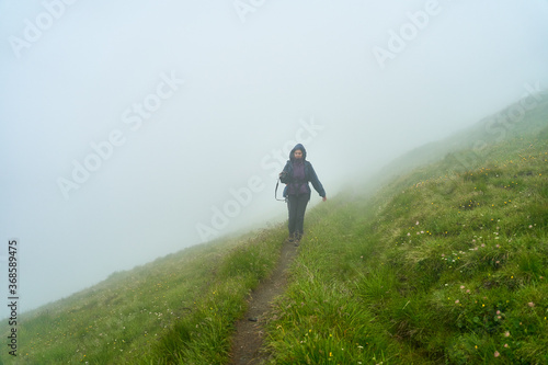 Woman hiker on a trail in the mountains