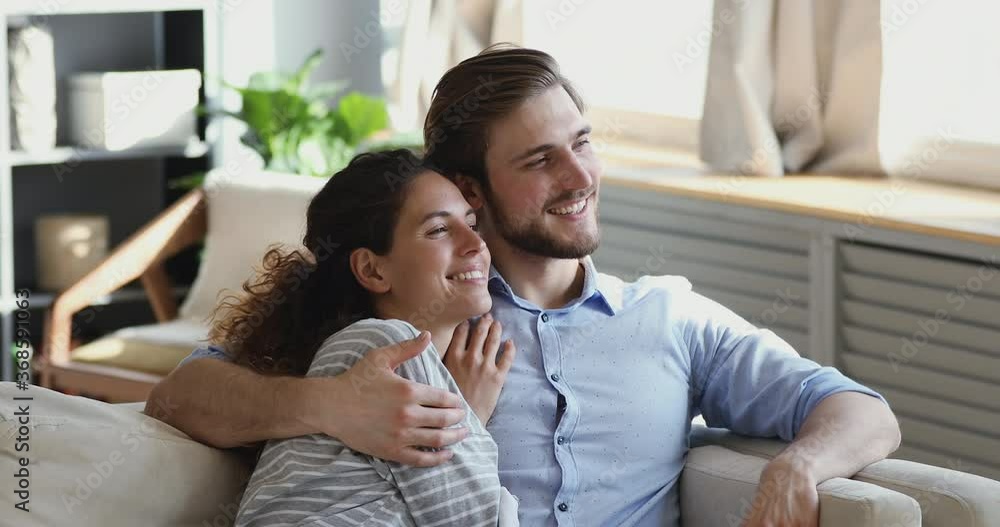 Head shot dreamy loving couple enjoying romantic moment together indoors. Happy young man cuddling beautiful woman, spending free weekend honeymoon time in own house, recollecting memories at home. Head shot dreamy loving couple enjoying romantic moment together indoors. Happy young man cuddling beautiful woman, spending free weekend honeymoon time in own house, recollecting memories at home.