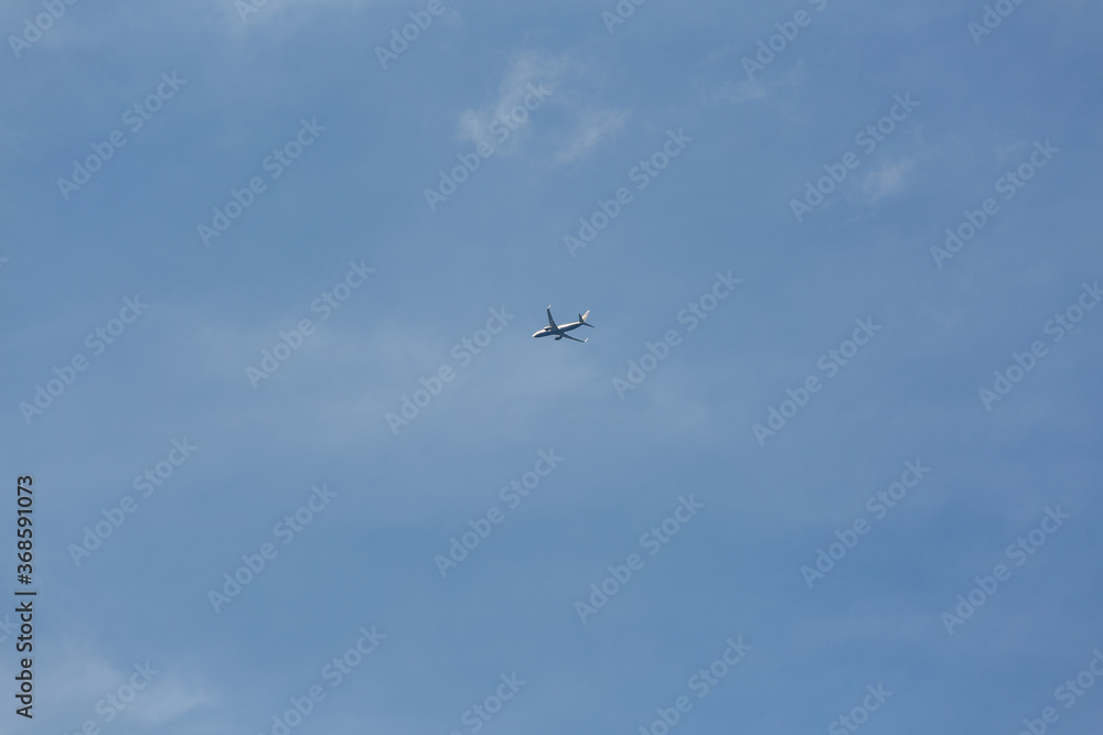 flying airplane in the blue sky