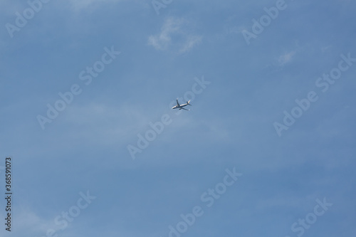 flying airplane in the blue sky