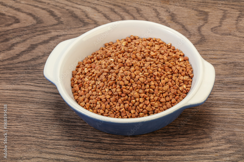 Raw buсkwheat cereal in the bowl Raw buсkwheat cereal in the bowl
