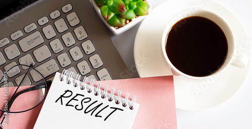 Office supplies, devices, coffee cup and glasses on white table with text RESULT
