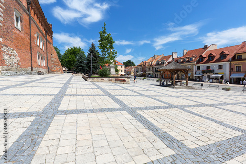 View on market with Sandomierz gothic Town Hall and old wooden well, Sandomierz, Poland © mychadre77