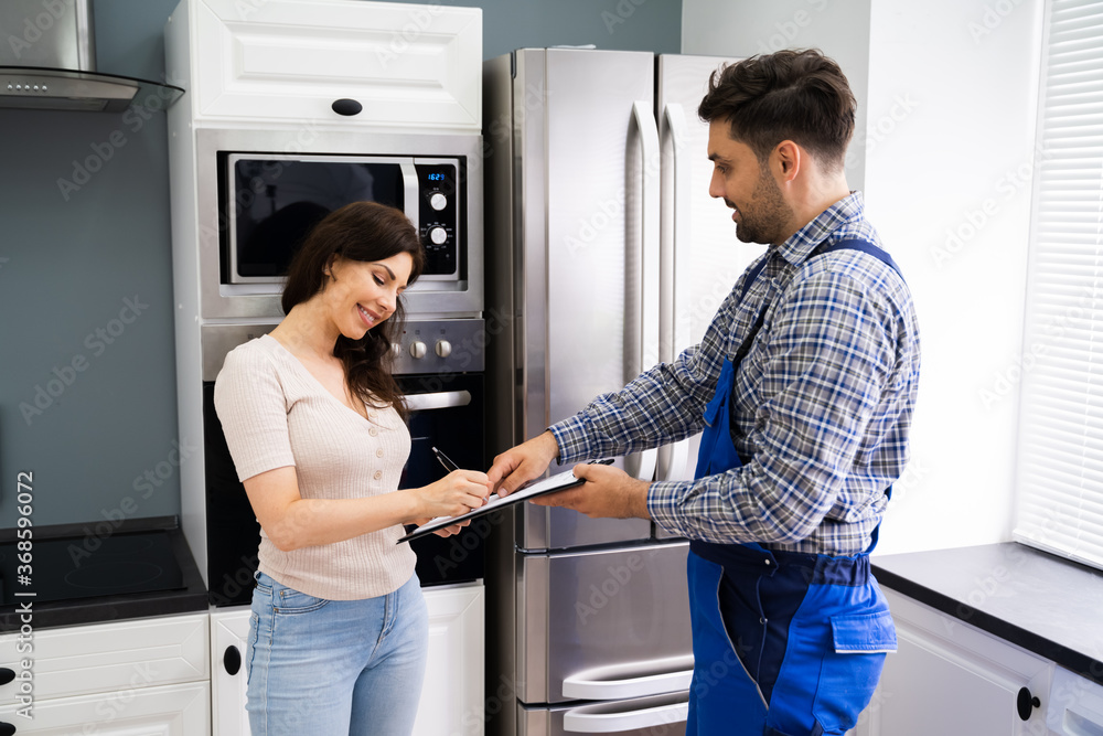 Happy Customer Woman Signing Plumber Invoice Happy Customer Woman Signing Plumber Invoice