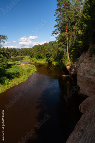 Gauja River in the summer, view from shore. view from red rocks ''Erglu klintis''