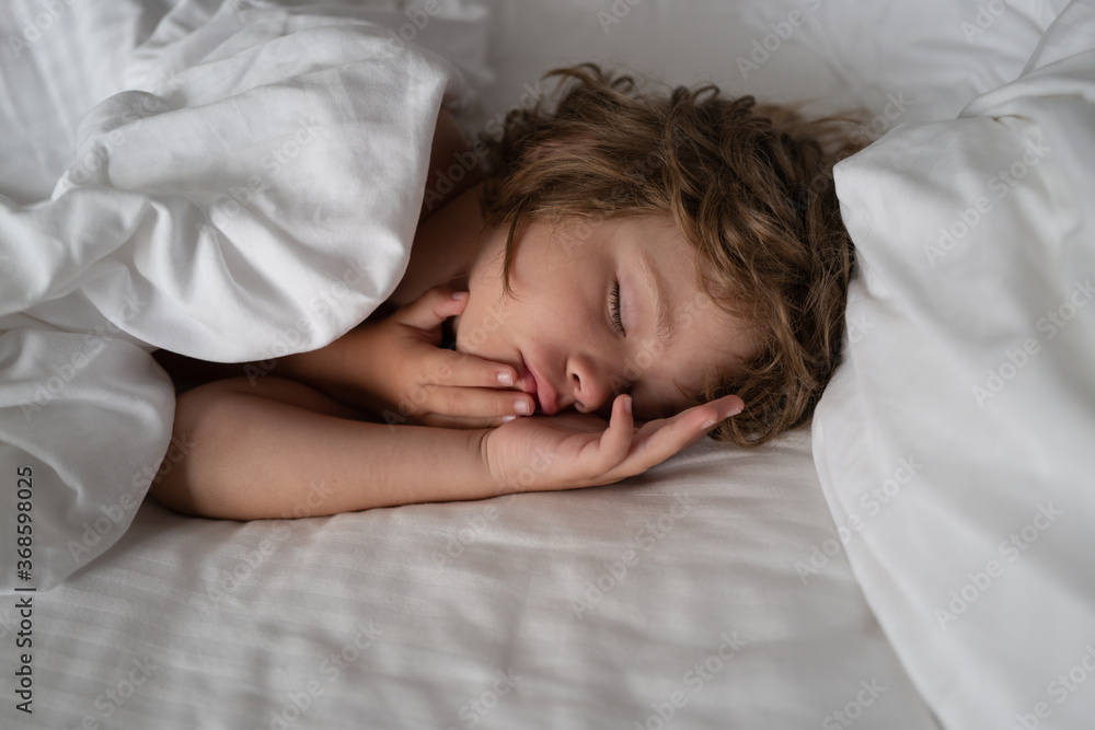 Kids sleep on bed. Good night. Calm adorable Child lying on soft pillows. Kids sleep on bed. Good night. Calm adorable Child lying on soft pillows.