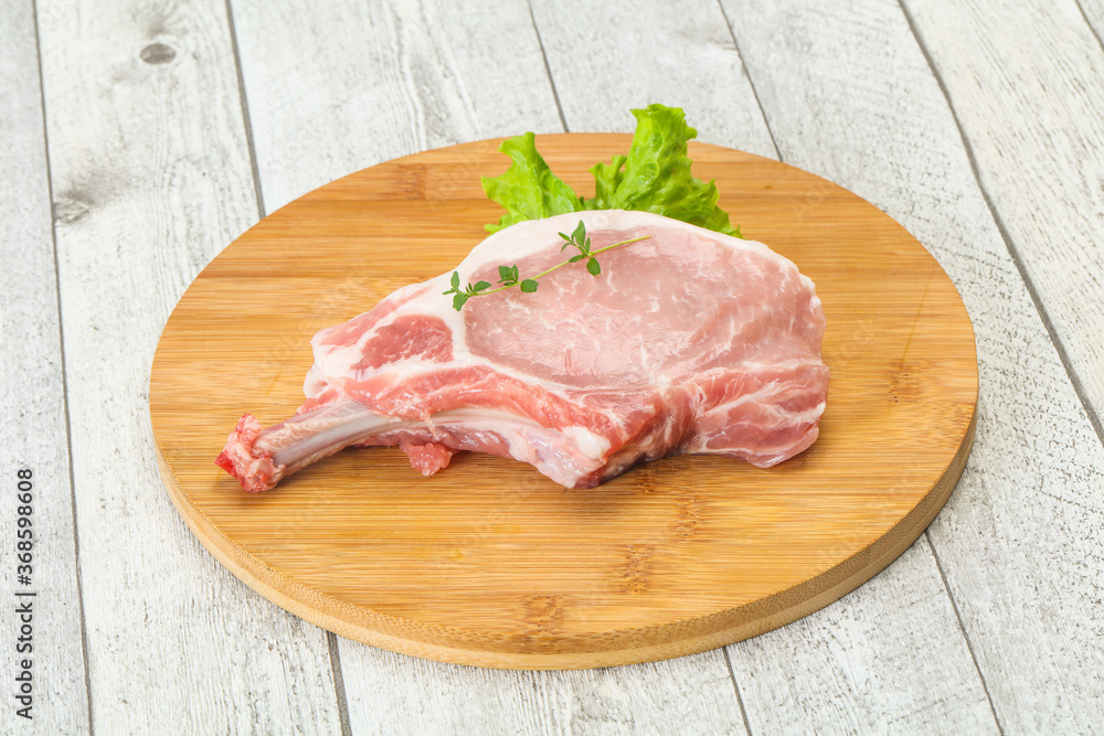 Raw pork bone steak over wooden