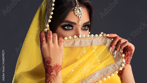 Portrait of a beautiful indian girl  .India woman in traditional sari dress and jewelry.