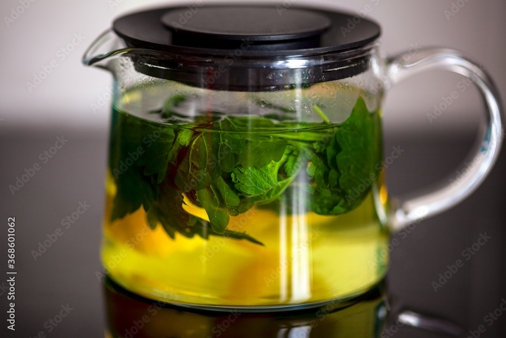 Mint and lemon brewing in glass teapot Mint and lemon brewing in glass teapot