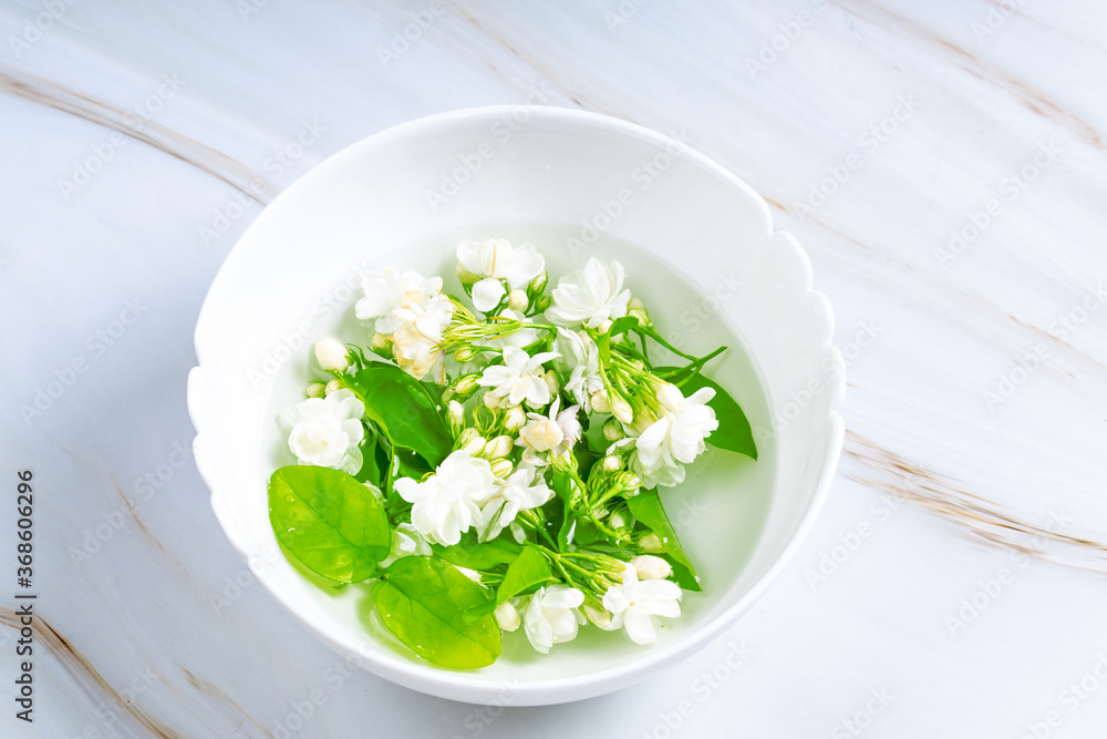 White petals of jasmine with green leaves White petals of jasmine with green leaves