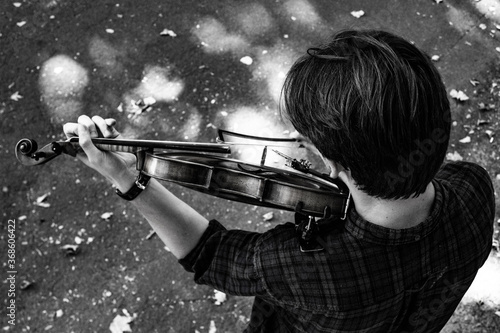 man in park with a violin