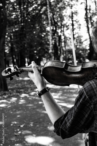 man in park with a violin