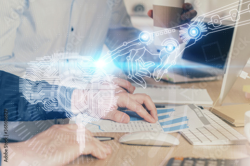 Man with computer background with brain theme hologram. Concept of brainstorm. Double exposure.