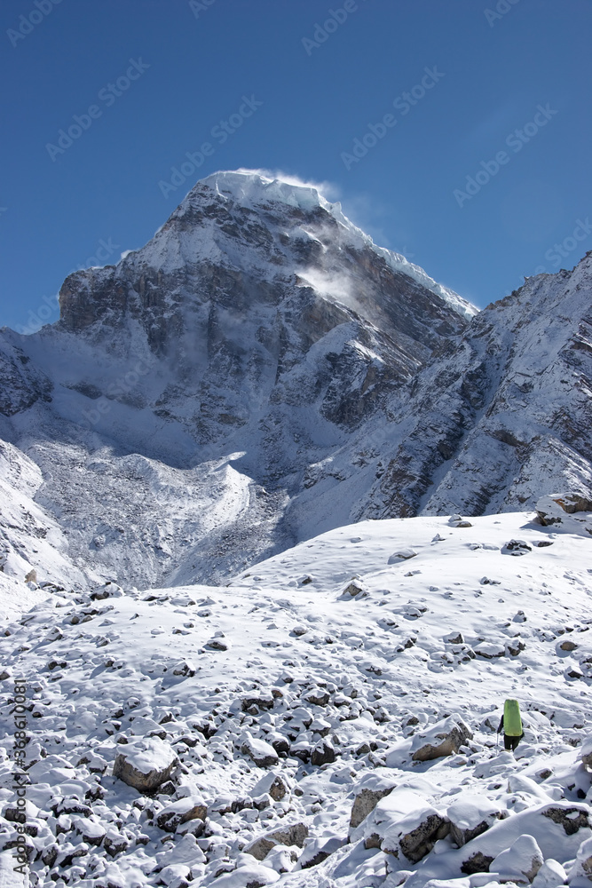 Mountaineer going toward Kanchung mountain covered with snow, Himalayas, Nepal