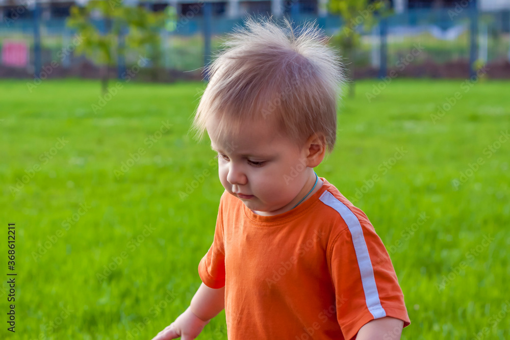 Child. Playing in the yard. Baby's emotions. Summer. Sunny day. Happy baby. Child. Playing in the yard. Baby's emotions. Summer. Sunny day. Happy baby.