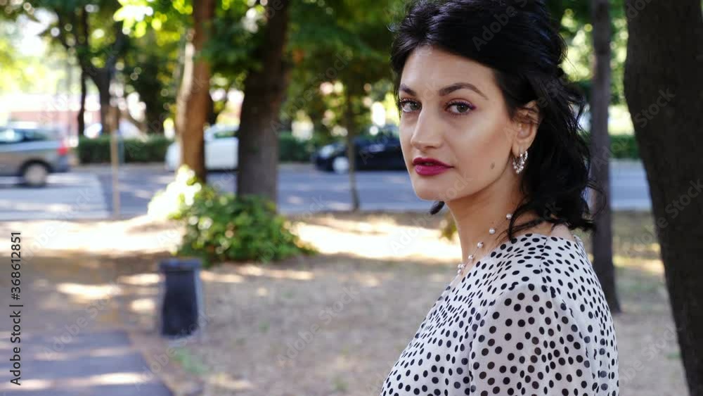 sensual woman in the city turning looking at camera and keeps walking sensual woman in the city turning looking at camera and keeps walking