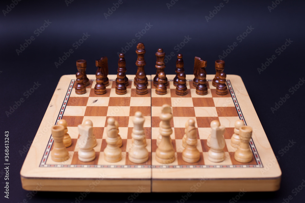 A game of chess, the beginning of a chess game two sides opposite each other. A game of chess, the beginning of a chess game two sides opposite each other.