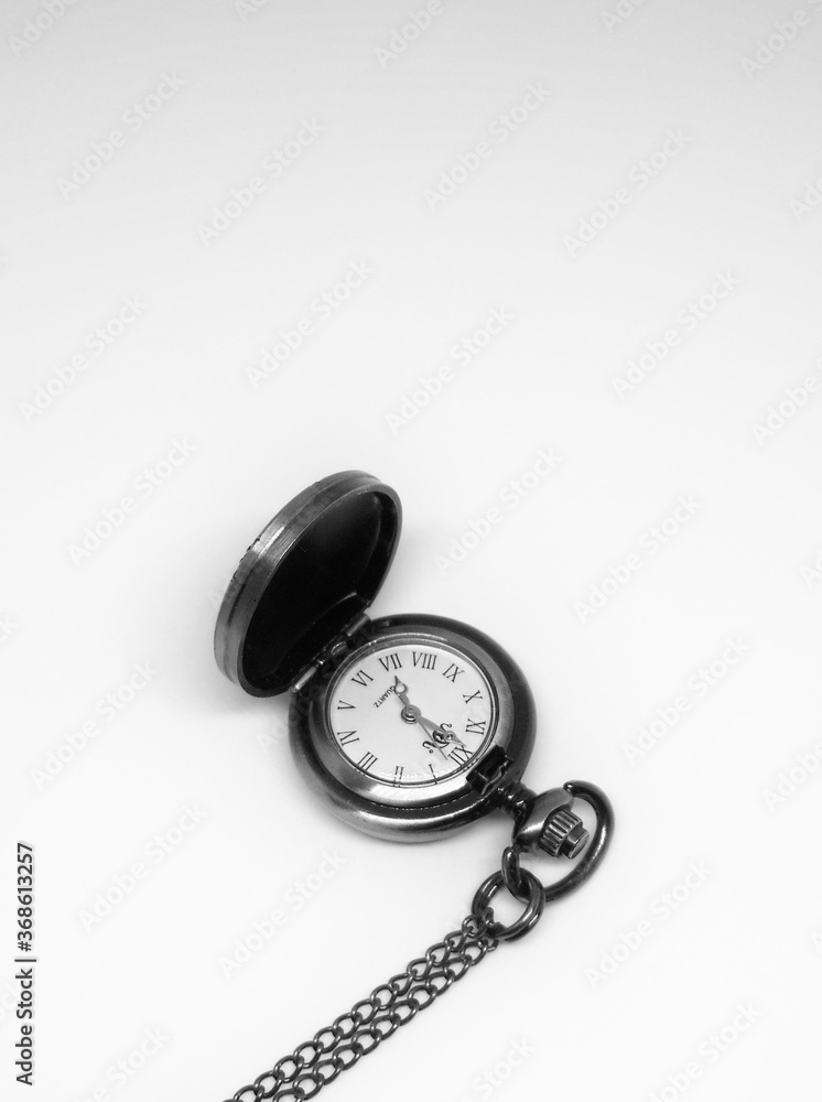 Mandalay/ Myanmar- August 1 2020: A bronze quartz pocket watch with hunter-case and watch chain. Mandalay/ Myanmar- August 1 2020: A bronze quartz pocket watch with hunter-case and watch chain.