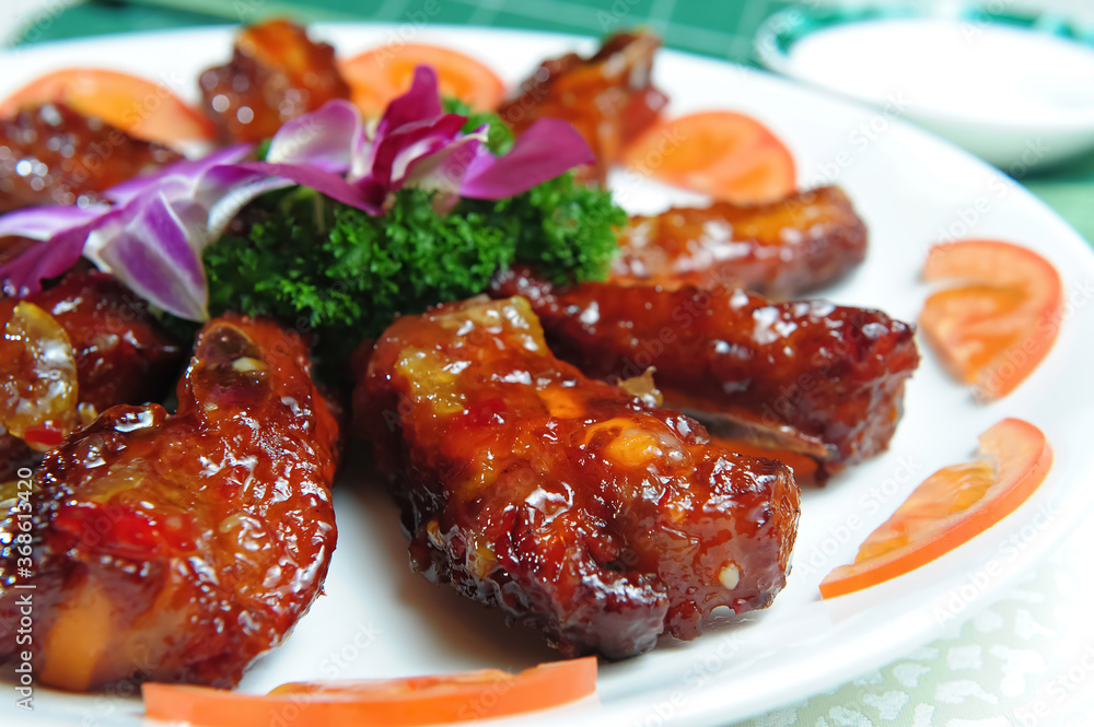 A Dish Of Pork Ribs With Sweet And Sour Sauce