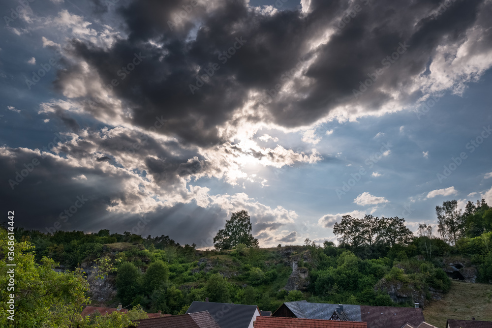 Dramatic sky over village in Franconian Switzerland on sunny summer day Dramatic sky over village in Franconian Switzerland on sunny summer day